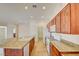 Bright kitchen featuring wooden cabinets, granite countertops, tile flooring, and modern white appliances at 3429 Glacial Lake St, Las Vegas, NV 89122