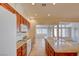Bright kitchen features wooden cabinets, granite countertops, tile flooring, and modern white appliances at 3429 Glacial Lake St, Las Vegas, NV 89122