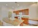 Bright kitchen features wooden cabinets, granite countertops, and a central island with a built in sink at 3429 Glacial Lake St, Las Vegas, NV 89122