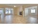 Open-concept living room with tile flooring, a cozy fireplace, and abundant natural light at 3429 Glacial Lake St, Las Vegas, NV 89122