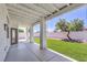 Covered back patio overlooks the manicured lawn and sculpted landscaping at 3693 Miguels Ln, Las Vegas, NV 89120