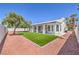 Large backyard with a covered patio, synthetic grass and desert landscaping at 3693 Miguels Ln, Las Vegas, NV 89120