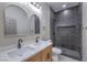Modern bathroom featuring a double vanity, stylish mirrors, and a tiled walk-in shower at 3693 Miguels Ln, Las Vegas, NV 89120