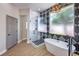 Luxurious bathroom with a walk-in shower, soaking tub, and modern fixtures at 3693 Miguels Ln, Las Vegas, NV 89120