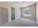 Well-lit bedroom with a large arched window and plush carpeting at 3693 Miguels Ln, Las Vegas, NV 89120