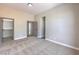 Bright bedroom featuring soft carpeting and a view into an ensuite bathroom and closet at 3693 Miguels Ln, Las Vegas, NV 89120