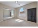 Bedroom with large sliding door closet, arched window and neutral-toned walls at 3693 Miguels Ln, Las Vegas, NV 89120
