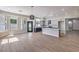 Open floor plan with modern kitchen, island, and natural light from large windows at 3693 Miguels Ln, Las Vegas, NV 89120