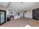 Bright, open living space features a modern kitchen, fireplace, and wood-look floors at 3693 Miguels Ln, Las Vegas, NV 89120