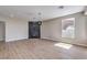 Modern living room with wood floors, featuring a tiled fireplace and a large window at 3693 Miguels Ln, Las Vegas, NV 89120