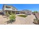 Large backyard area with artificial turf, drought-resistant landscaping, covered patio and storage shed at 3821 Nesting Wren Dr, North Las Vegas, NV 89084