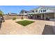 A backyard with drought-resistant landscaping, artificial turf, and a covered patio for outdoor enjoyment at 3821 Nesting Wren Dr, North Las Vegas, NV 89084