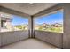 Covered balcony showcasing views of the peaceful neighborhood and distant mountains on a clear day at 3821 Nesting Wren Dr, North Las Vegas, NV 89084