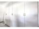 A wall of modern white cabinets with sleek silver handles offers ample storage space at 3821 Nesting Wren Dr, North Las Vegas, NV 89084