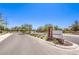 A neighborhood entrance is marked by brick pillars, landscaping, and a 'Queensbury' sign at 3821 Nesting Wren Dr, North Las Vegas, NV 89084