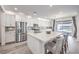 Bright kitchen featuring a large island, stainless steel appliances, and modern finishes with gray wood flooring at 3821 Nesting Wren Dr, North Las Vegas, NV 89084