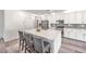 Bright kitchen featuring a large island, stainless steel appliances, and modern finishes with gray wood flooring at 3821 Nesting Wren Dr, North Las Vegas, NV 89084