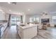 Modern open kitchen featuring a marble island, stainless appliances, and light wood flooring at 3821 Nesting Wren Dr, North Las Vegas, NV 89084
