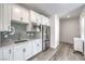 A modern kitchen with white cabinetry, stainless steel appliances, and beautiful backsplash at 3821 Nesting Wren Dr, North Las Vegas, NV 89084