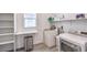 Bright laundry room with shelving, modern washer and dryer, and a pull-down table at 3821 Nesting Wren Dr, North Las Vegas, NV 89084