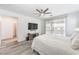 Bright main bedroom featuring wood flooring, a ceiling fan, and access to a private balcony at 3821 Nesting Wren Dr, North Las Vegas, NV 89084
