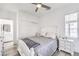 Bright main bedroom featuring wood-look flooring, a ceiling fan and an ensuite bathroom at 3821 Nesting Wren Dr, North Las Vegas, NV 89084