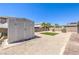 The backyard has drought-resistant landscaping, artificial turf, and a storage shed for outdoor equipment at 3821 Nesting Wren Dr, North Las Vegas, NV 89084