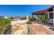 Stone patio boasts a pergola, lush landscaping, and views of the surrounding landscape at 454 Intrepid Ct, Boulder City, NV 89005