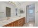 Bright bathroom with dual sinks, a large mirror, and a separate tub, all with tile flooring at 454 Intrepid Ct, Boulder City, NV 89005