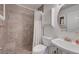 Tiled bathroom with shower, cabinet, toilet, and sink with an oval mirror at 454 Intrepid Ct, Boulder City, NV 89005
