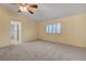 Neutral bedroom with carpet flooring, a window with blinds, and access to the bathroom at 454 Intrepid Ct, Boulder City, NV 89005