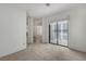 Bright carpeted bedroom featuring a sliding glass door to the outside at 454 Intrepid Ct, Boulder City, NV 89005
