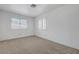 Clean and simple bedroom with carpet, two windows, and neutral walls, ideal for relaxation at 454 Intrepid Ct, Boulder City, NV 89005