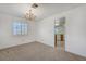 Comfortable dining area with a chandelier and carpet flooring, next to the kitchen at 454 Intrepid Ct, Boulder City, NV 89005