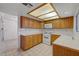 Traditional kitchen with wood cabinets, white appliances, and tile backsplash at 454 Intrepid Ct, Boulder City, NV 89005
