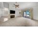 Bright living room featuring a fireplace, carpet floors, and sliding glass doors to the patio at 454 Intrepid Ct, Boulder City, NV 89005
