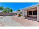 Spacious backyard featuring a covered patio, gravel landscaping, and a defined walkway at 4724 Victoria Beach Way, Las Vegas, NV 89130