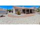 Rear view showing gravel landscaping, covered patio, storage shed, and tile roof at 4724 Victoria Beach Way, Las Vegas, NV 89130