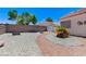 Well-kept backyard with a gravel landscape, brick perimeter, and easy access to a storage shed at 4724 Victoria Beach Way, Las Vegas, NV 89130