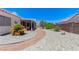 Picturesque backyard with stone landscaping, a covered patio, and mature plants at 4724 Victoria Beach Way, Las Vegas, NV 89130