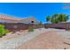 Backyard with gravel landscaping, mature plants, brick walls, and a fountain at 4724 Victoria Beach Way, Las Vegas, NV 89130