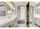 Large primary bathroom with dual sinks, mirrors, and a view leading to the closet at 4724 Victoria Beach Way, Las Vegas, NV 89130