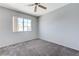 Bedroom with neutral walls, carpet flooring, window for natural light, and a ceiling fan at 4724 Victoria Beach Way, Las Vegas, NV 89130