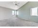 Bedroom features carpeted floors, vaulted ceiling, and a ceiling fan, complemented by natural lighting at 4724 Victoria Beach Way, Las Vegas, NV 89130
