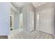 Bright entryway featuring tile flooring, neutral walls, and a glass front door at 4724 Victoria Beach Way, Las Vegas, NV 89130