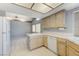 Bright kitchen featuring tile countertops, wood cabinets, tile floors, and stainless steel appliances at 4724 Victoria Beach Way, Las Vegas, NV 89130