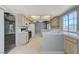 Bright kitchen featuring tile countertops, wood cabinets, tile floors, and stainless steel appliances at 4724 Victoria Beach Way, Las Vegas, NV 89130