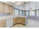 Bright kitchen featuring tile countertops, wood cabinets, tile floors, and stainless steel appliances at 4724 Victoria Beach Way, Las Vegas, NV 89130