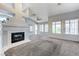 Bright living room featuring plush carpet, large windows, and a tiled fireplace at 4724 Victoria Beach Way, Las Vegas, NV 89130