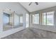 Inviting living room with a cozy fireplace, mirrors, neutral carpet, and sunny backyard views at 4724 Victoria Beach Way, Las Vegas, NV 89130